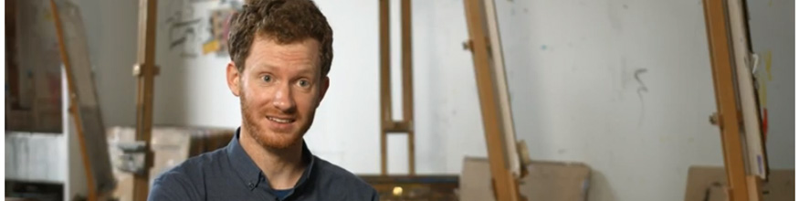 Academic smiling in front of easels